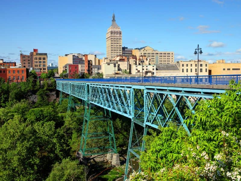 Land surveying in Rochester New York featuring the Genesee River Gorge, historic bridge, and downtown skyline